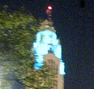 The blue lit top of a building