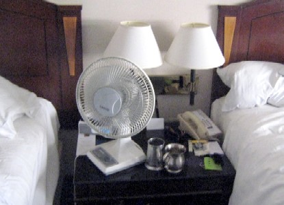 A fan on the bedside table