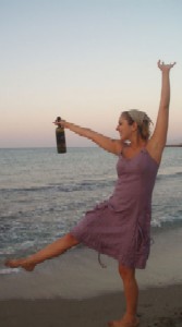 Georgia dancing by the lake with a wine bottle