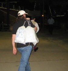 Shannon carrying bags of ice