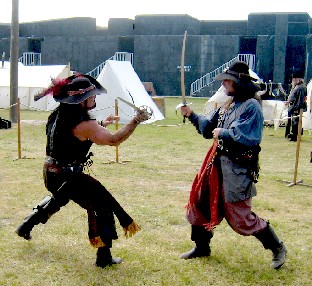 Handsome Devlin and Captain Black practice sword fighting