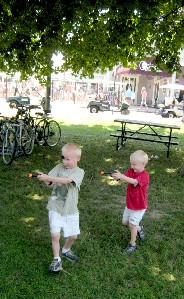 Two of the boys aim their pistols at other people