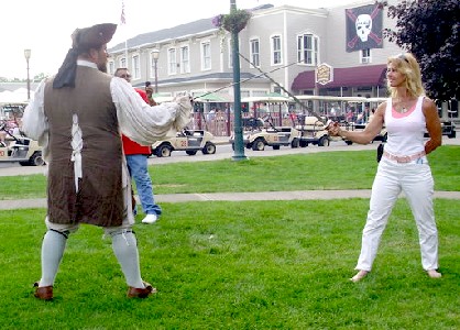 M.A. d'Dogge sword fighting with a woman in white