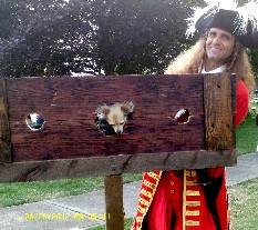 Mike holding Grace in the stocks