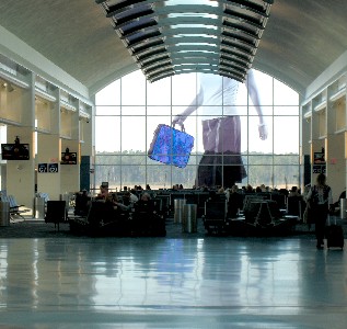 Large woman walking by the window in the airport